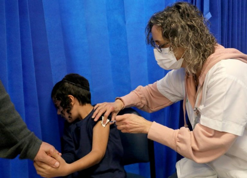 An Israeli health worker administers a dose of the Pfizer-BioNTech vaccine