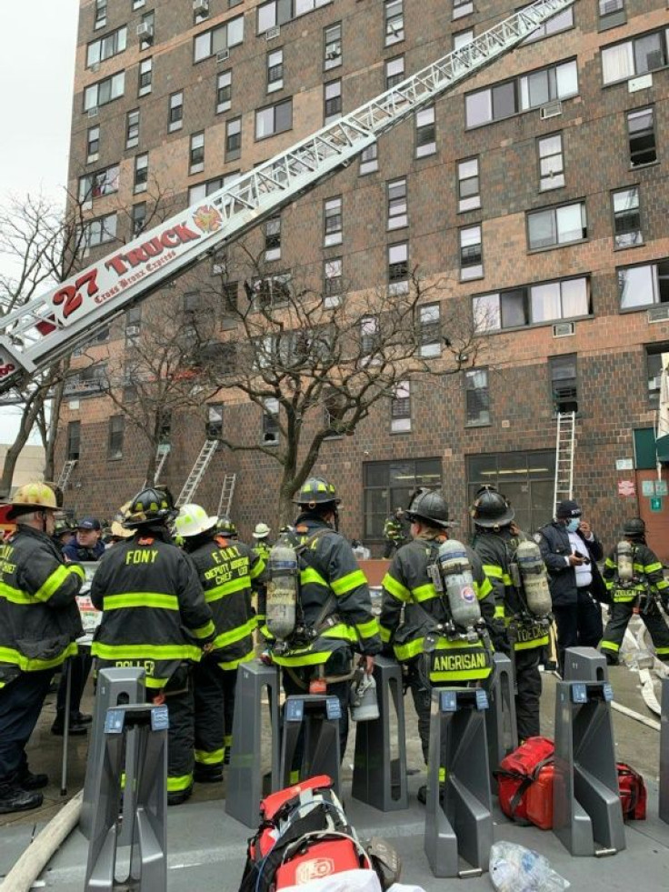 This handout picture posted on the Twitter account of the New York City Fire Department (FDNY), January 9, 2022 shows Firefighters working outside an apartment building after a fire in the Bronx, New York