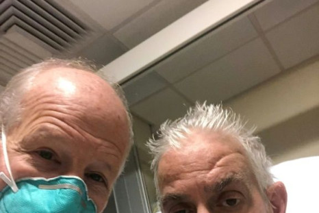 This handout photo released by the University of Maryland School of Medicine on January 10, 2022 shows surgeon Dr. Bartley Griffith (L) with patient David Bennett, Sr., who received a heart implant from a genetically modified pig