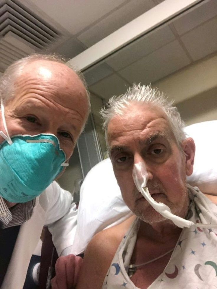 This handout photo released by the University of Maryland School of Medicine on January 10, 2022 shows surgeon Dr. Bartley Griffith (L) with patient David Bennett, Sr., who received a heart implant from a genetically modified pig
