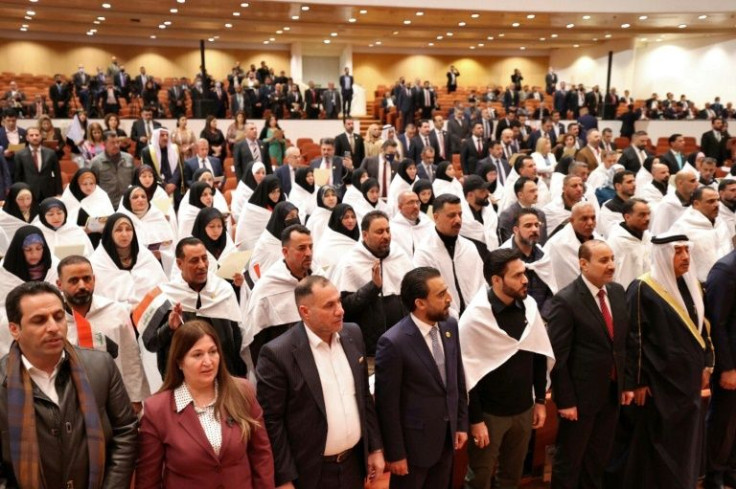 Iraqi lawmakers attend the inaugural session of parliament -- analysts warn there are still several hard steps ahead before the formation of a new government