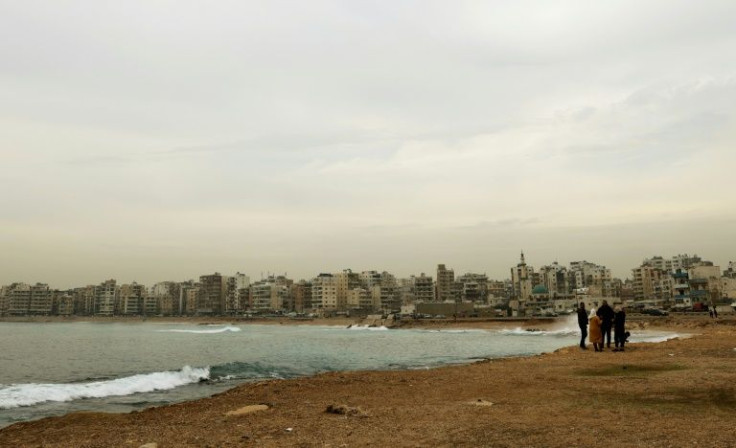Lebanese walk along the shore in Tripoli -- the UN refugee agency says the number of Lebanese trying to take illicit sea journeys out of the country increased in 2021