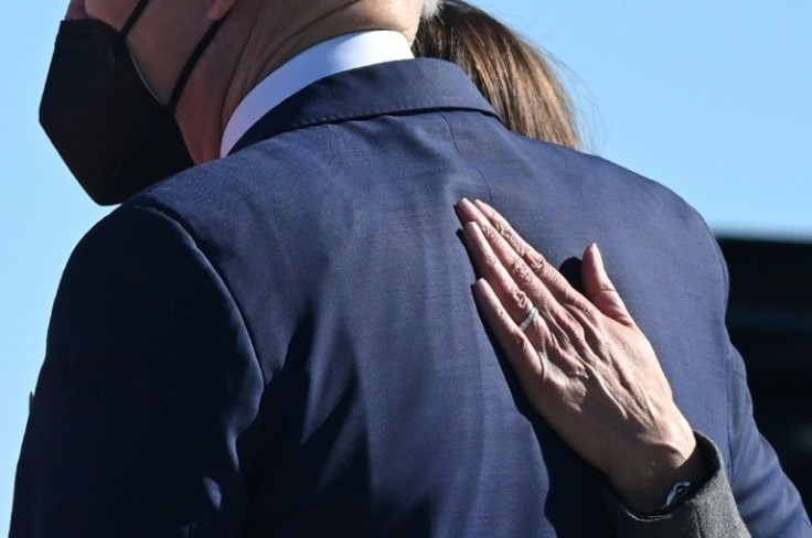 US President Joe Biden has his back patted by Vice President Kamala Harris upon arrival at Atlanta Hartsfield-Jackson International Airport