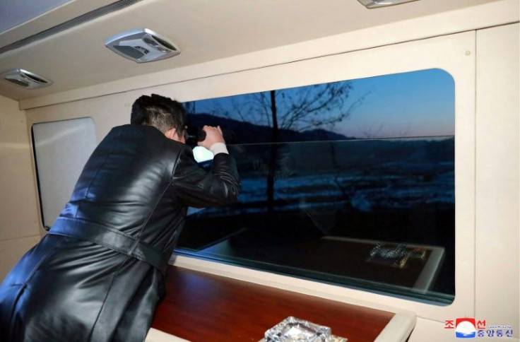 North Korean leader Kim Jong Un watches Tuesday's missile test through binoculars