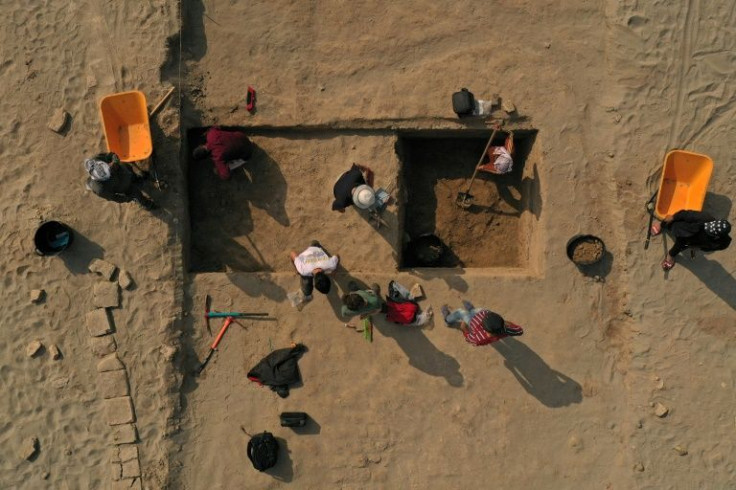 Members of a French-Iraqi archaeological expedition work on a dig at the site of the Sumerian city-state of Larsa, in southern Iraq