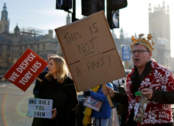 Demonstrators held placards demanding Prime Minister Boris Johnson quit as he offered apologies over a lockdown-breaching party