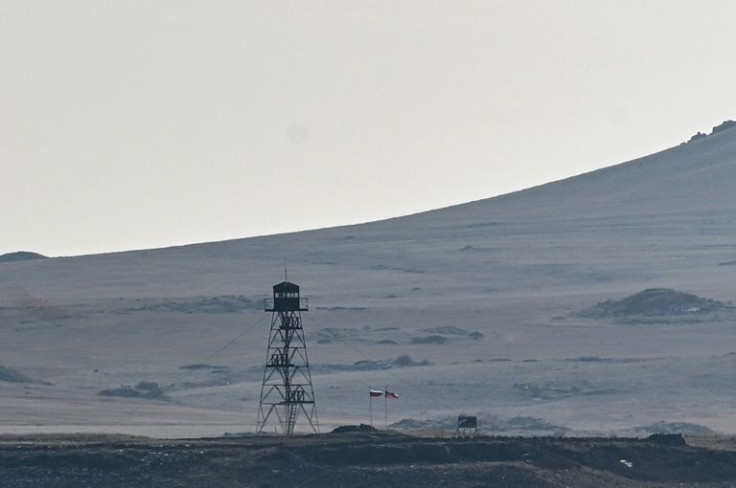 A Russian flag flies over one of the border crossings, where Moscow has set up a base in support of its Armenian ally