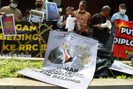 People protest against China's claims on the disputed South China Sea outside the Chinese embassy in Jakarta on December 8, 2021