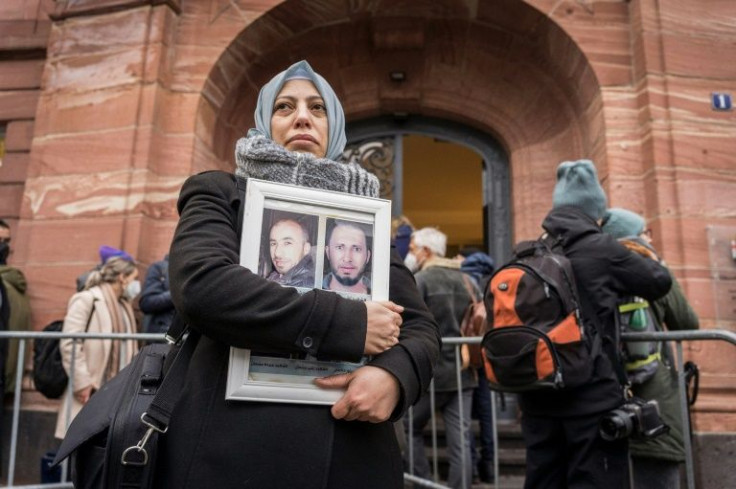 Campaigners for the victims of the Syrian regime wait for the verdict outside the Koblenz court