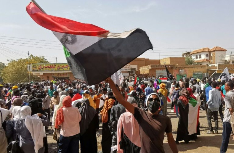A Sudanese demonstrator waves a national flag during a protest against the October 2021 military coup, in the capital Khartoum