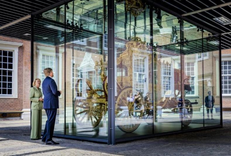 King Willem-Alexander looks at the Golden Coach during the opening, in June 2021, of an exhibition on the Netherlands' colonial past in the Amsterdam museum