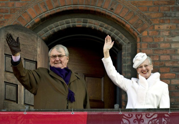 Queen Margrethe II (R) and Prince Consort Henrik wave from the balcony of the Copenhagen City Hall on her 40th jubilee