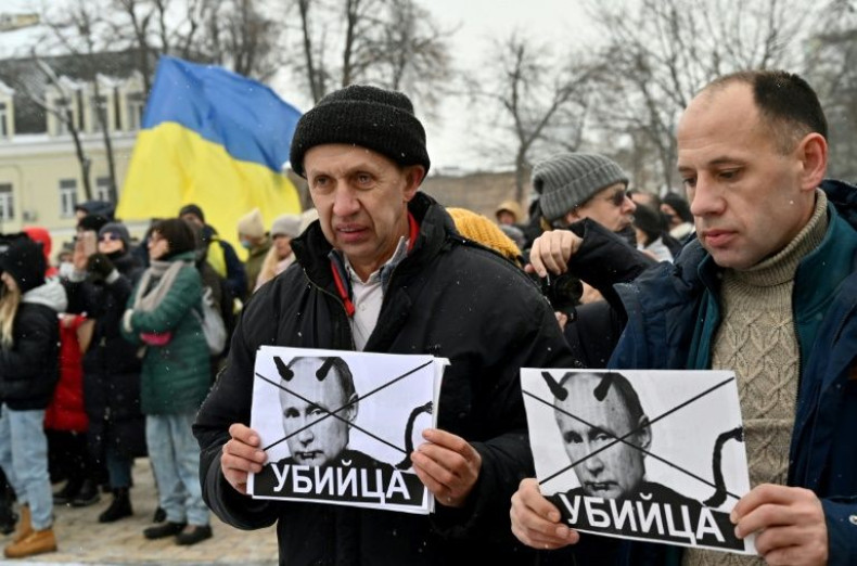 Demonstrators hold placards calling Russian President Vladimir Putin a "killer" in Kyiv on January 9, 2022 amid a Russian military buildup