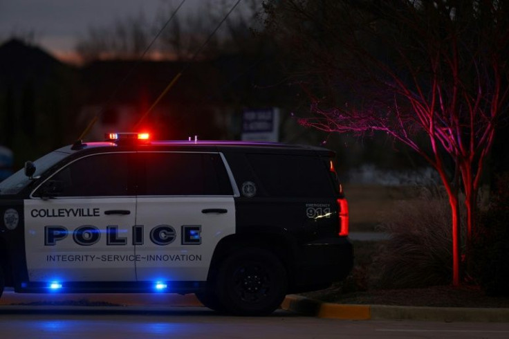 A Police car is seen driving close to the Congregation Beth Israel Synagogue in Colleyville, Texas, some 25 miles (40 kilometers) west of Dallas