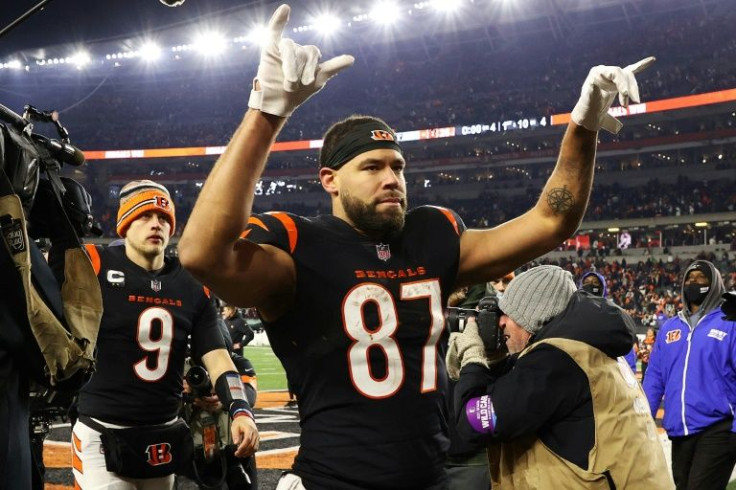 Cincinnati Tight end C.J. Uzomah and quarterback Joe Burrow  celebrate the Bengals' 26-19 victory over the Las Vegas Raiders in the first round of the NFL playoffs