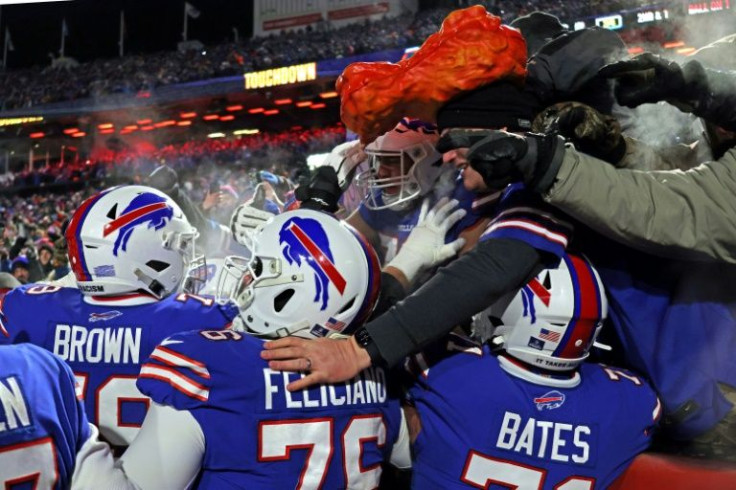 Buffalo Bills players celebrate with fans after a touchdown in their 47-17 victory over the New England Patriots in the first round of the NFL playoffs