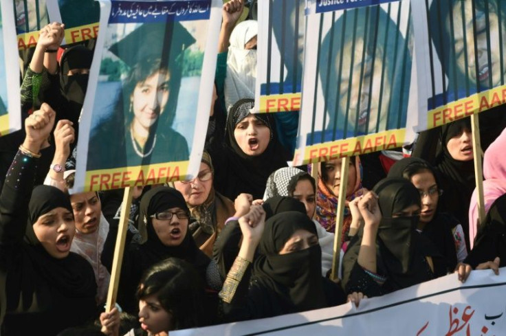 Pakistani protesters carry portraits of Aafia Siddiqui, whose imprisonment in the US has long been a matter of tension between Islamabad and Washington