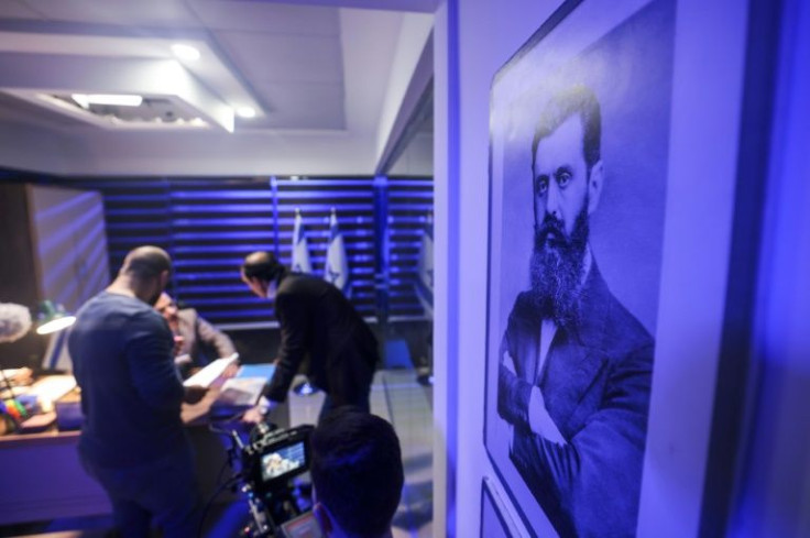 A portrait of the founder of modern political Zionism Theodor Hertzl hangs on the set as Palestinian actors and crew shoot a scene of 'Qabdat al-Ahrar'