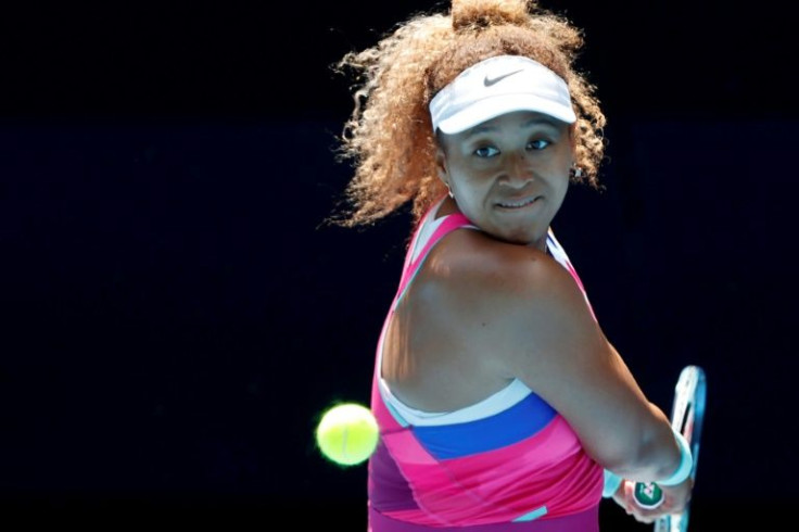 Japan's Naomi Osaka hits a return against Colombia's Camila Osorio during their women's singles match on day one of the Australian Open