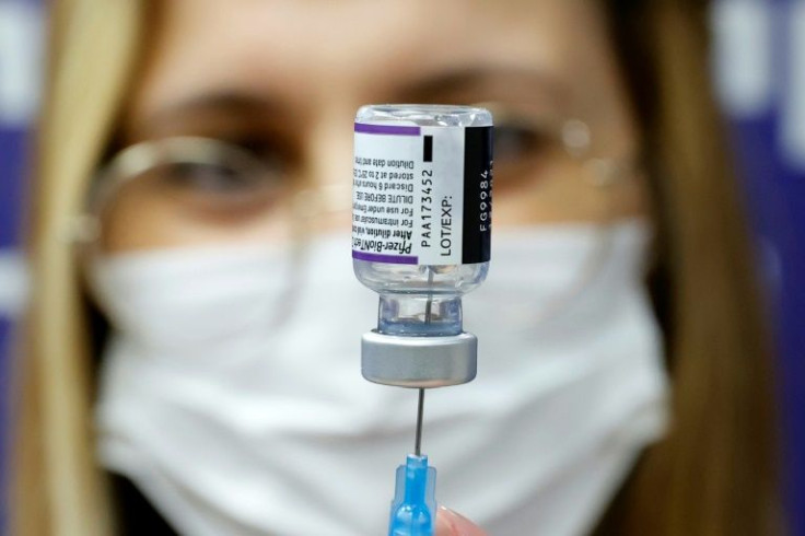 A medic prepares a dose of Pfizer vaccine to be used as a fourth shot at Sheba Medical Center in Ramat Gan, near Tel Aviv in December 2021