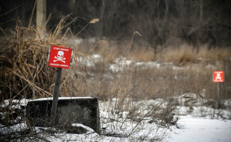 This photograph taken near Donetsk, capital of a self-proclaimed Donetsk People's Republic (PDR) in eastern Ukraine, on January 18, 2022, shows landmine warning signs in the village of Vesyoloye