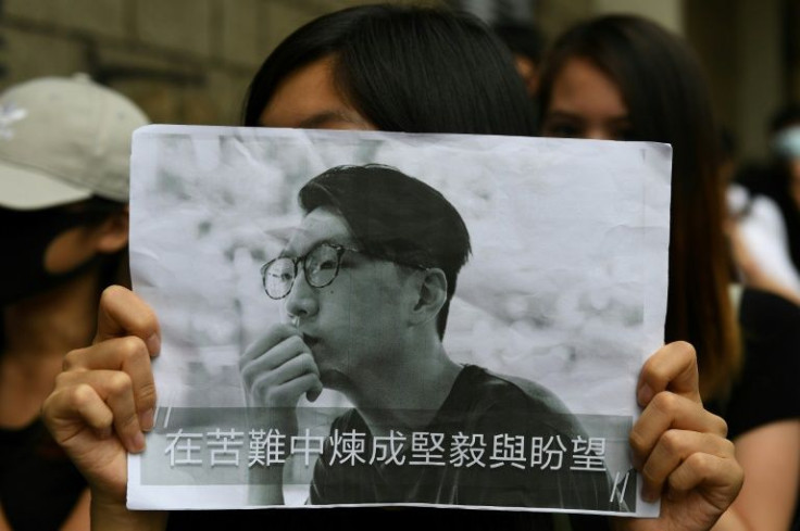 A demonstrator holds up placard with a photo of activist Edward Leung