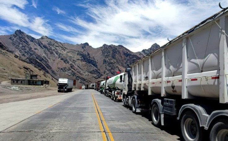 Picture released by Telam on January 17, 2022, showing trucks lining up in Las Cuevas, in the Argentine province of Mendoza, just before the Cristo Redentor-Libertadores international mountain pass across the Andes mountain range between Argentina and Chi