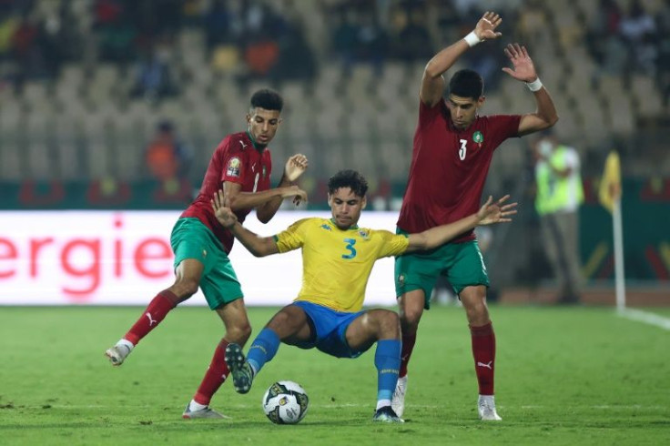 Anthony Oyono (C) of Gabon is put under pressure from Azzedine Ounahi (L) and Adam Masina (R) of Morocco during an Africa Cup of Nations Group C match in Yaounde on Tuesday.