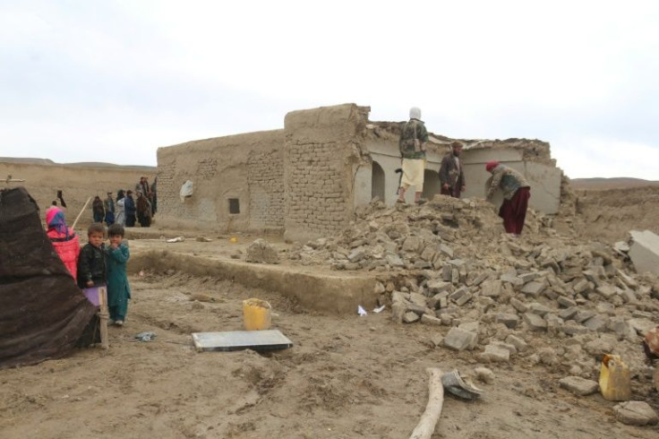 Residents examine a damaged house, in Qadis district in Afghanistan's western Badghis province, after twin quakes struck