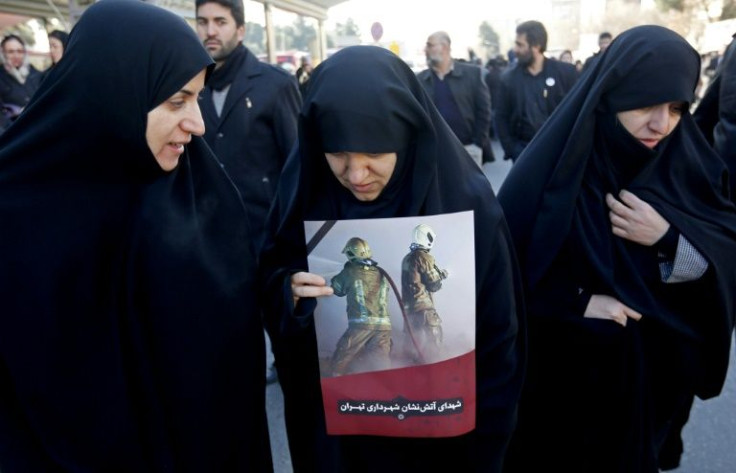 Iranian women mourn during the funeral procession on January 30, 2017 after the Plasco tower collapse killed 16 firefighters