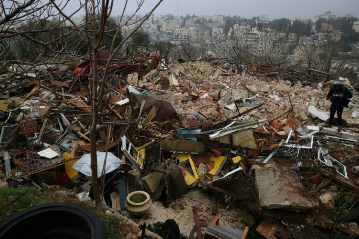 A Palestinian surveys what remains of the Salhiya family home in Israeli-annexed east Jerusalem after its demolition by Israeli police