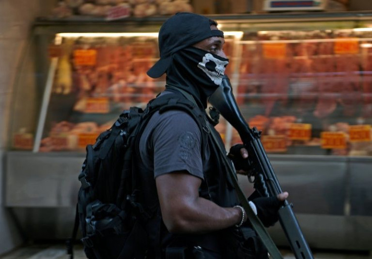 A police officer patrolls the streets of Rio de Janeiro on January 19, 2022 as part of an operation to retake gang-controlled favelas