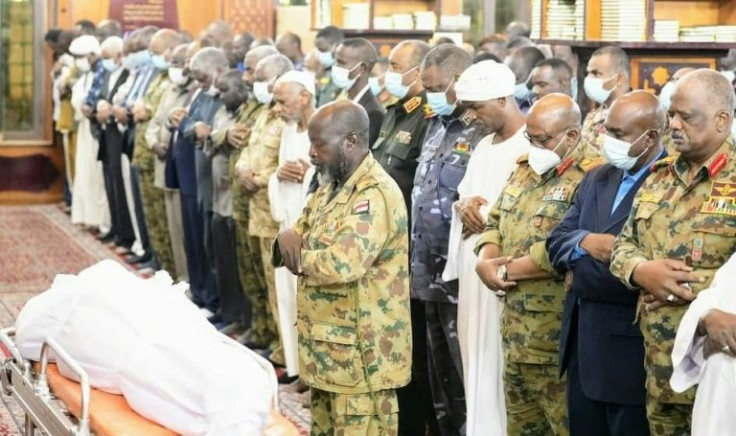 A picture released on January 13, 2022, shows Sudan's top General Abdel Fattah al-Burhan (front row 6th-R) attending the funeral prayer in Khartoum for Brigadier General Ali Bareema Hamad, slain during anti-coup protests