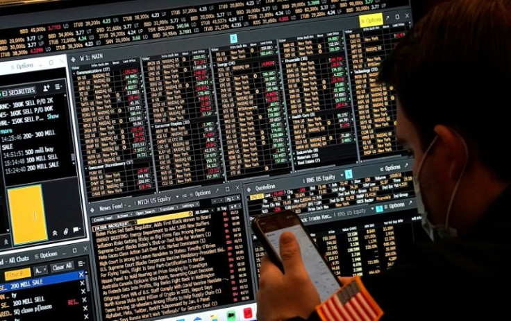 A trader works on the floor of the New York Stock Exchange at the closing bell January 14, 2022, in New York, New York