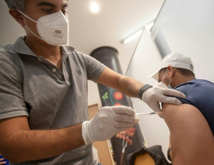 A man gets a Covid-19 jab at a vaccination station in Vienna on August 25, 2021; from February 2022, vaccinations against the virus will be mandatory for adults in Austria