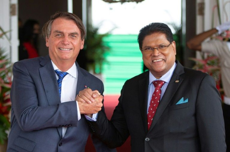 Suriname's President Chandrikapersad Santokhi (R) and Brazilian President Jair Bolsonaro  met at the Presidential Palace in Paramaribo on December 20, 2022