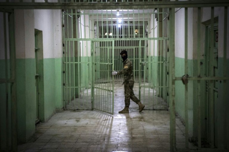 A file picture shows a member of the Syrian Democratic Forces (SDF) standing guard in a prison where suspected Islamic State group jihadists are jailed in Hasakeh