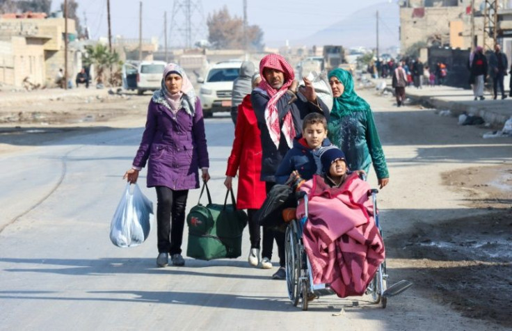 Syrians flee their homes in the Ghwayran neighbourhood of the northern city of Hasakeh on the third day of fighting between Islamic State group fighters and Kurdish forces after IS attacked a prison housing jihadists