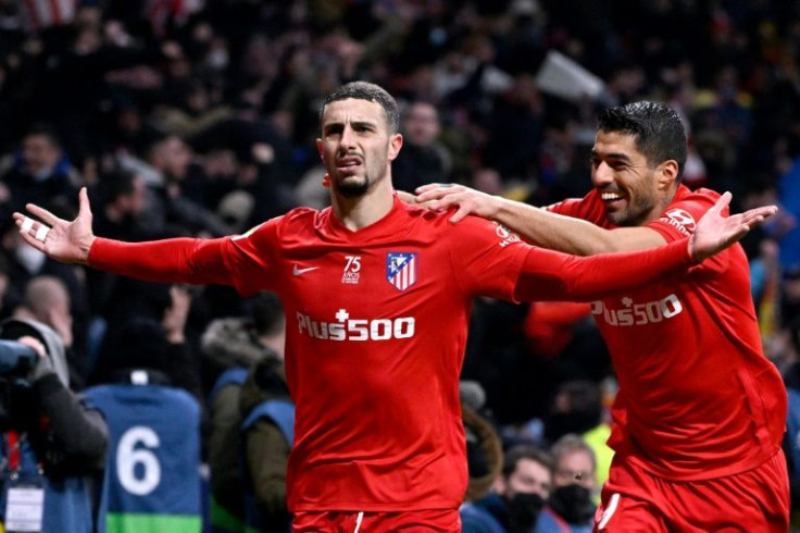 Mario Hermoso (left) celebrates with Luis Suarez after scoring the winner for Atletico Madrid against Valencia on Saturday