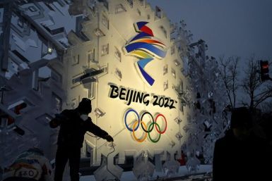 Workers set up an installation displaying the logo of the Beijing Winter Olympics