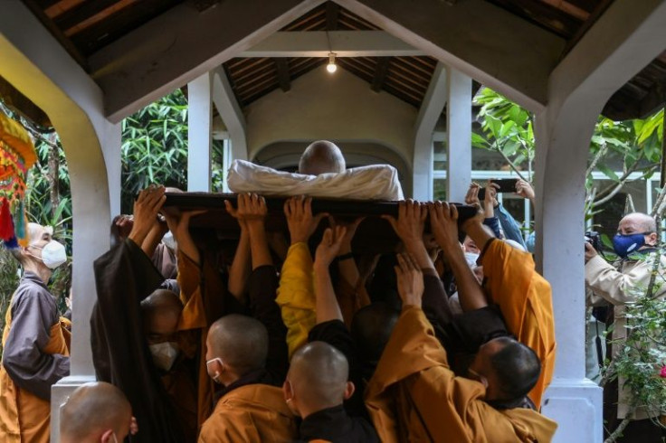 Buddhist monks carry the body of Zen master Thich Nhat Hanh, who died at the age of 95 and is credited with bringing mindfulness to the West