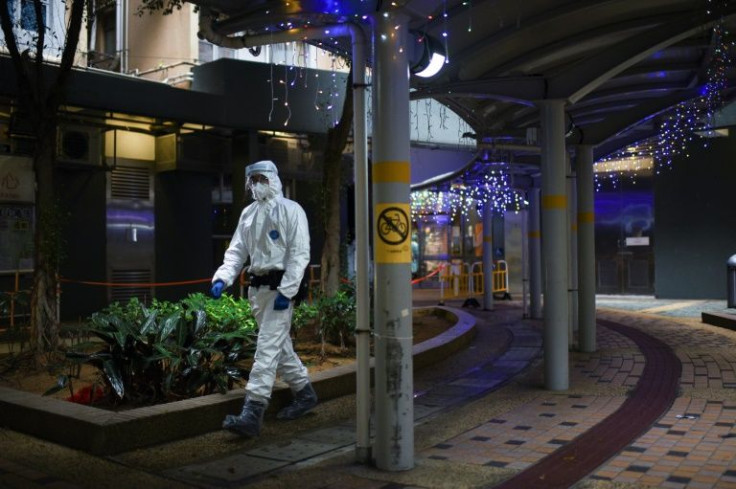 A health worker walks outside a building placed under lockdown in Kwai Chung, Hong Kong