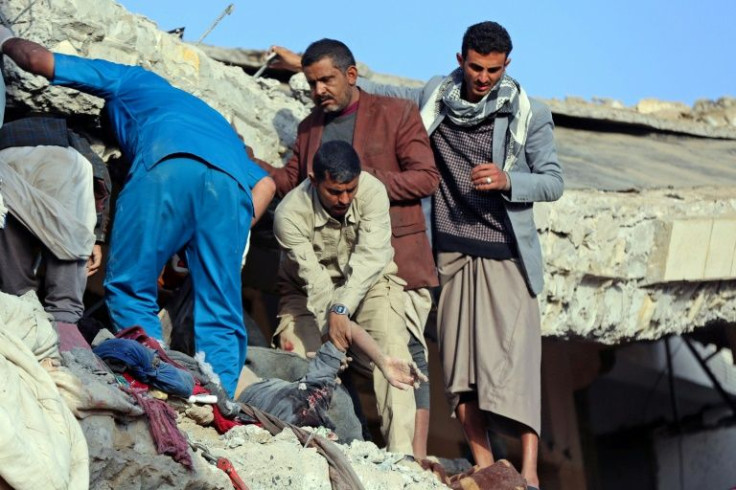 Yemenis search for survivors following a reported Saudi-led airstrike on a prison in the Huthi stronghold of Saada in the country's north