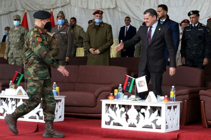 Libyan interim Prime Minister Abdulhamid Dbeibah (R) greets Lieutenant General Mohammad Ali al-Haddad (L), chief of the general staff of the Libyan army, during a military graduation ceremony in the capital Tripoli on January 23, 2022