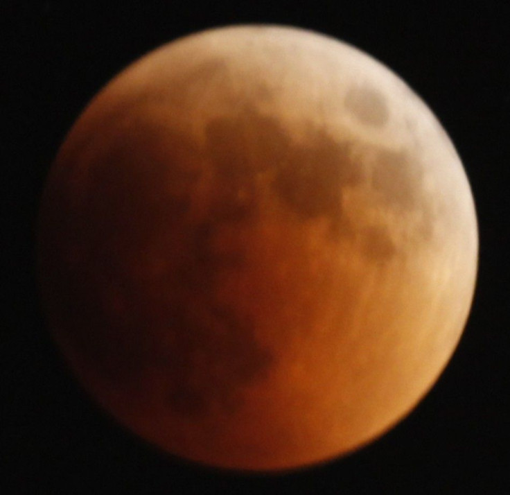 A shadow falls on the moon as it undergoes a total lunar eclipse as seen from Jerusalem