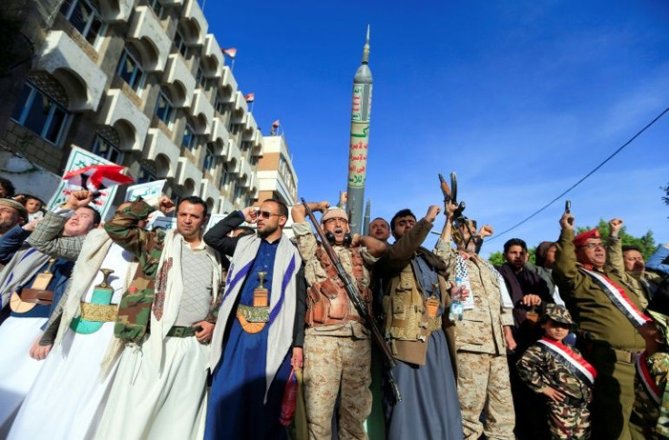 Supporters of Yemen's Huthi rebels march in the capital Sanaa carrying a mock rocket on January 21