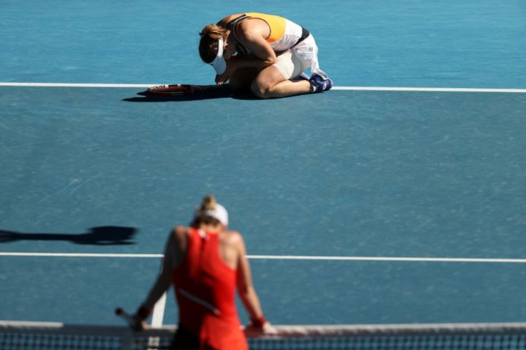 Alize Cornet (top) celebrates her win against an exhausted  Romania's Simona Halep