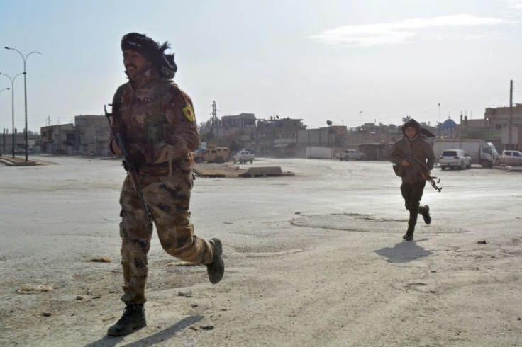 Syrian Democratic Forces (SDF) cross a street in the northern Syrian city of Hasakeh on January 23