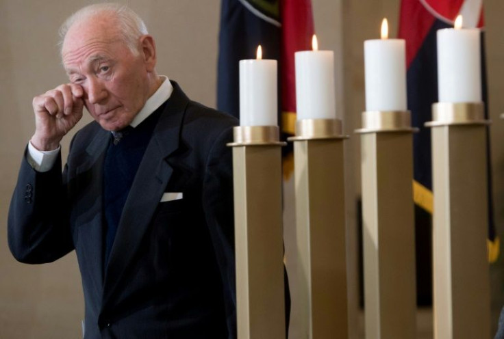 Holocaust survivor Mark Khazanov wipes his eyes after lighting a memorial candle during an annual remembrance ceremony for victims of the Holocaust and Nazi persecution hosted by the US Holocaust Memorial Museum in Washington, DC on April 9, 2018