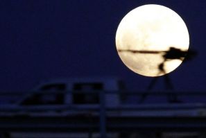 A heavy machine gun on a rebel fighter&#039;s vehicle is pictured against the moon during a total lunar eclipse in Benghazi